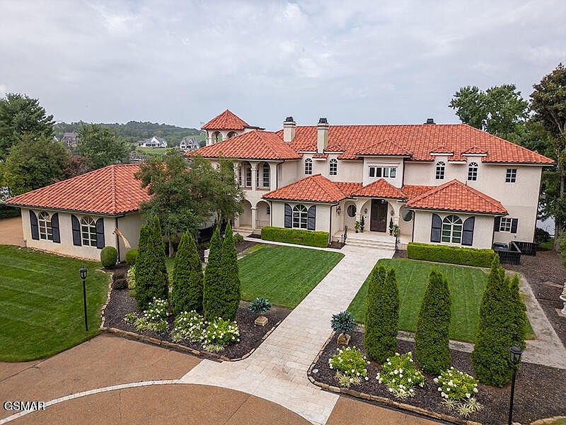 8719 Inlet Drive, a lakeside home surrounded by trees
